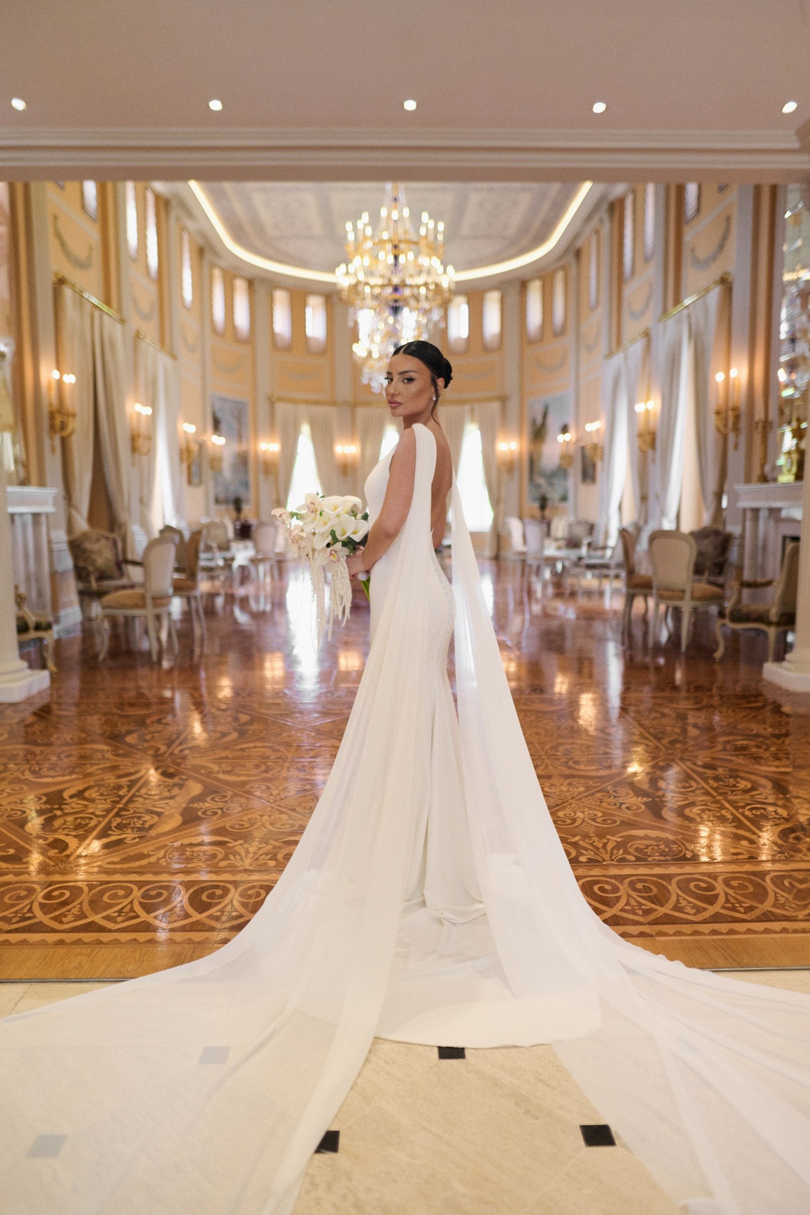 Bride's train laid out across the mirrored hall of the palace