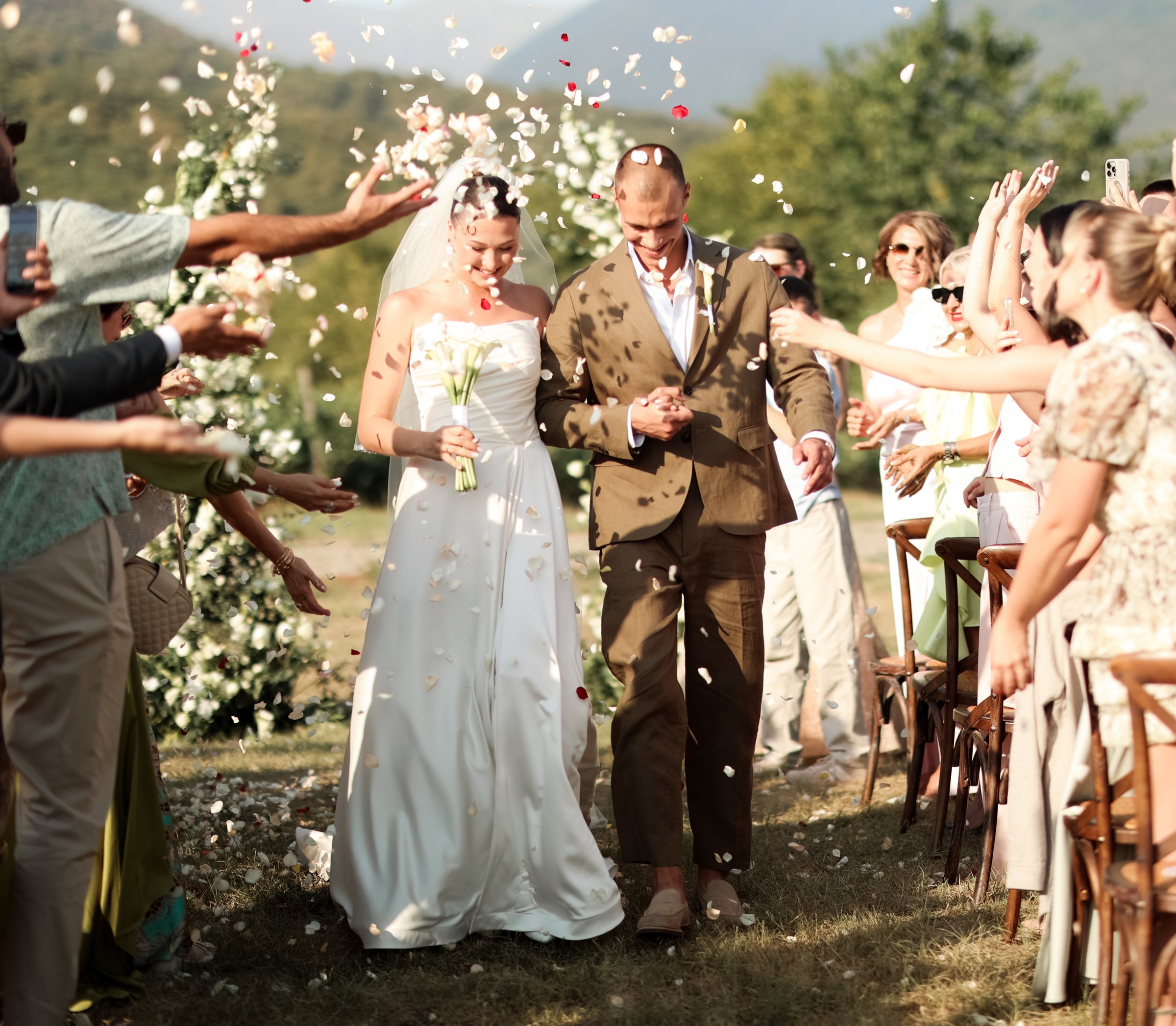 Guests shower the newlyweds with petals after the ceremony