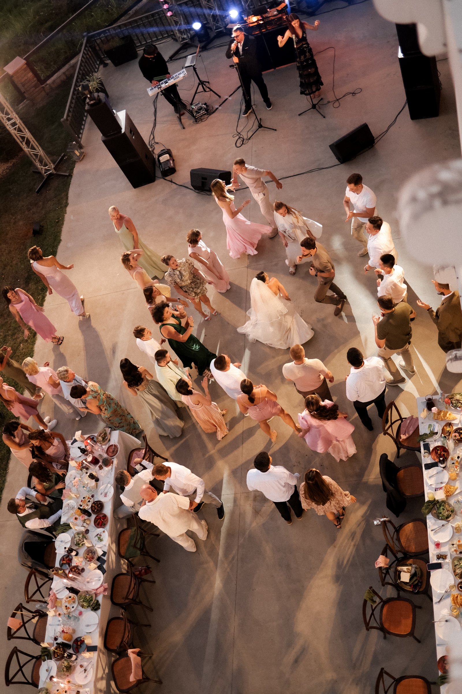 Open-air dancefloor and live band at night, seen from above
