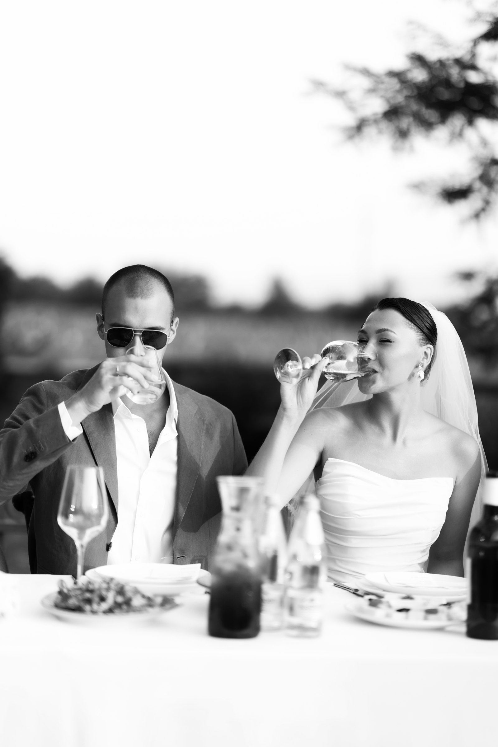 A quiet toast at the table, black and white
