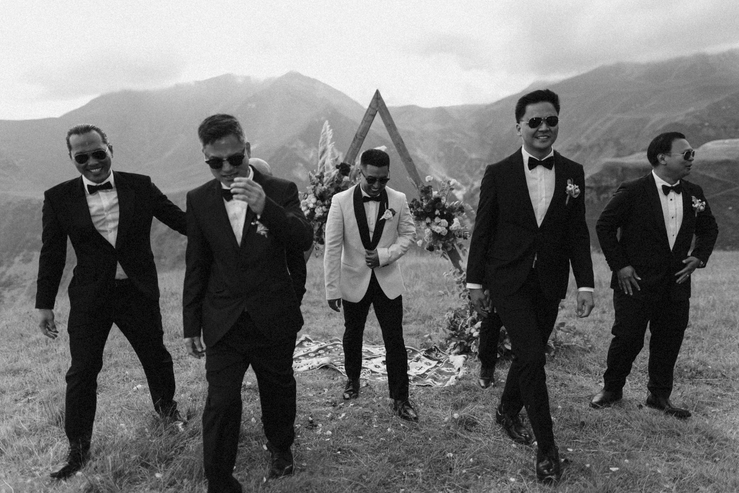 The groomsmen walk the plateau, black and white