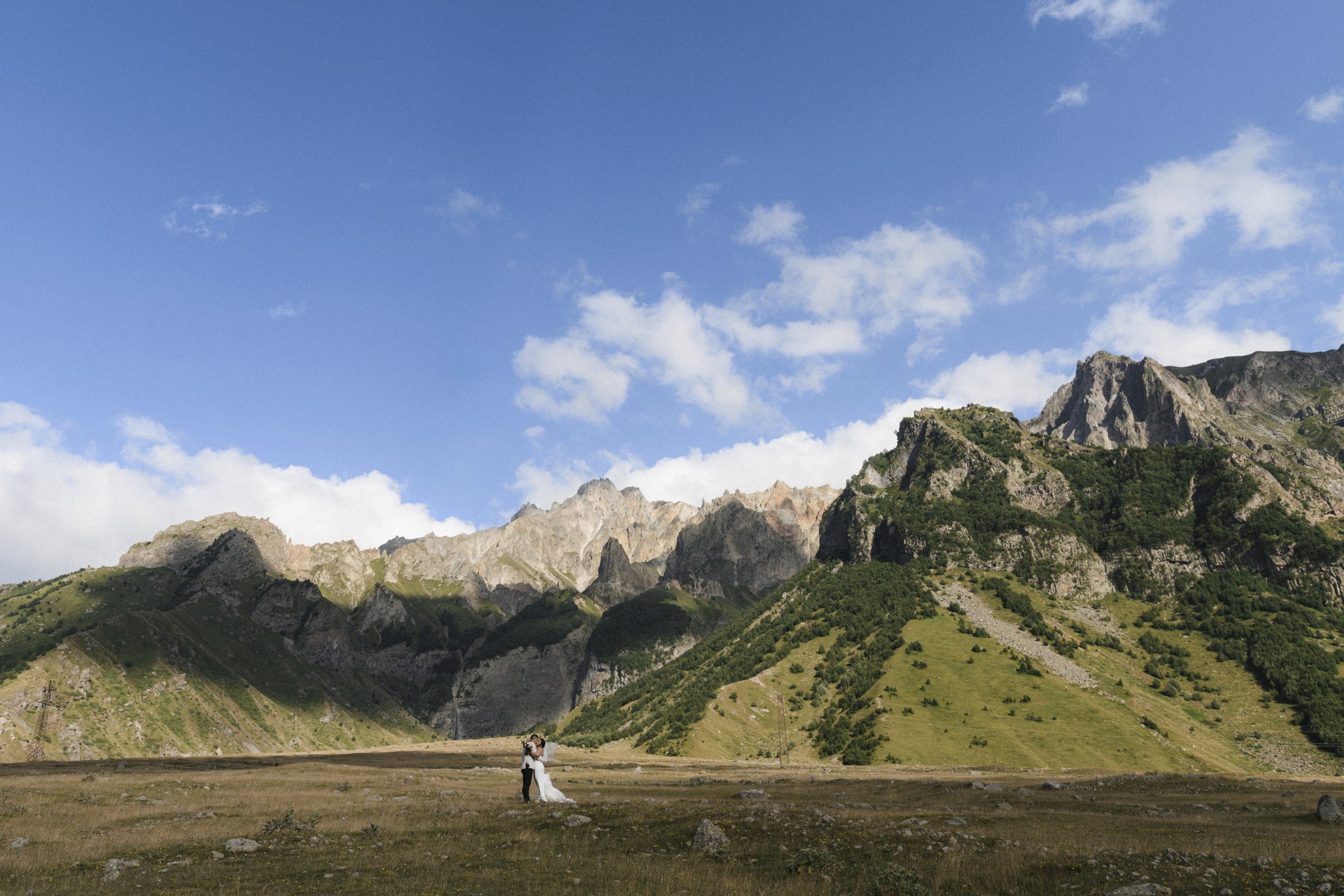 Two figures in the vast Kazbegi valley