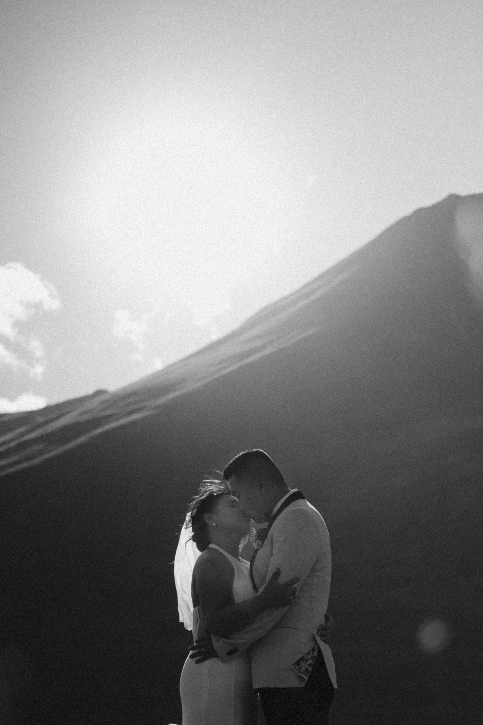 A kiss against the sun and the ridge, black and white