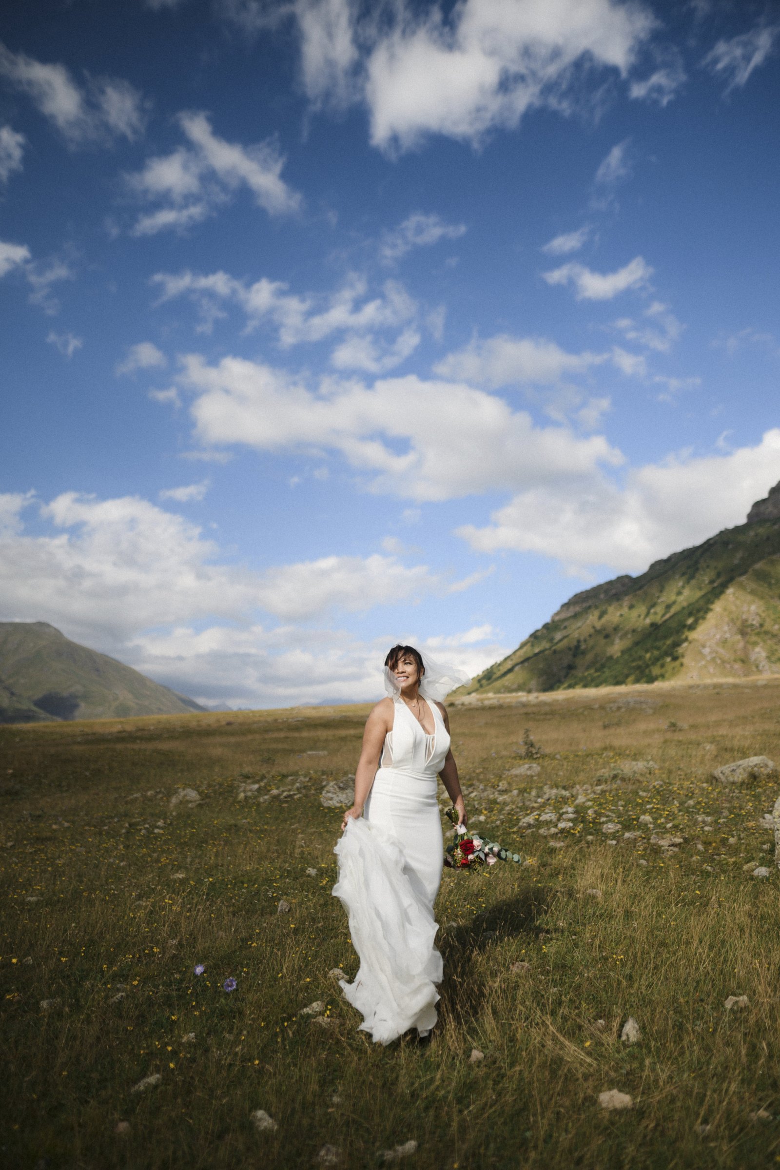 The bride alone in the valley grass