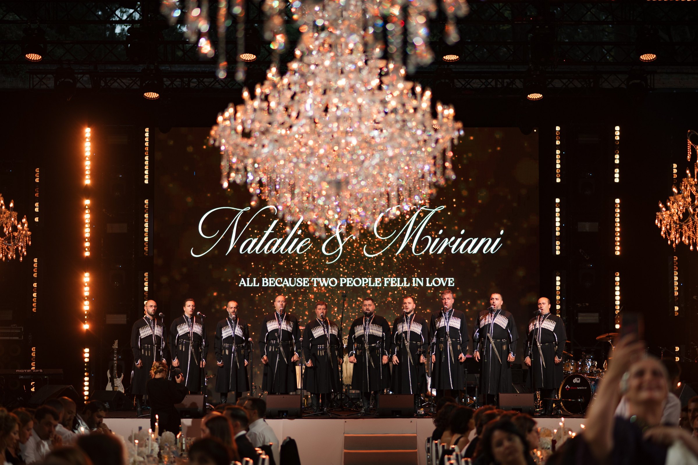 The Georgian choir on stage under the couple’s names