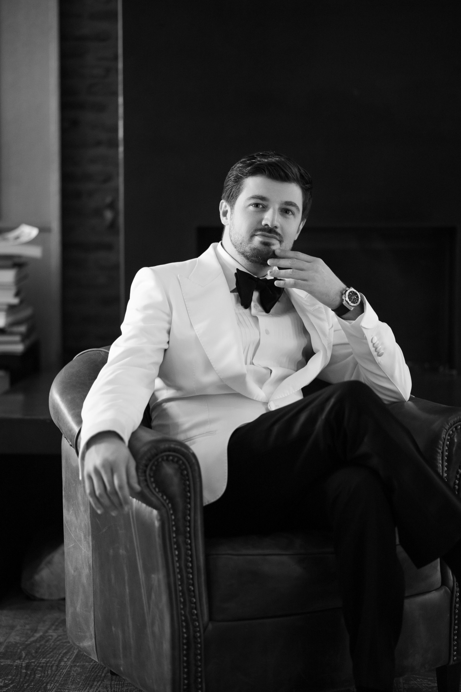 The groom in a white dinner jacket, black and white
