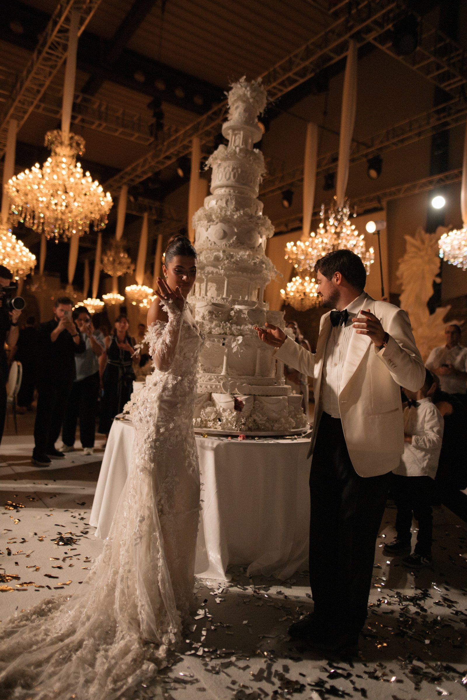 Cutting the cake as the confetti falls