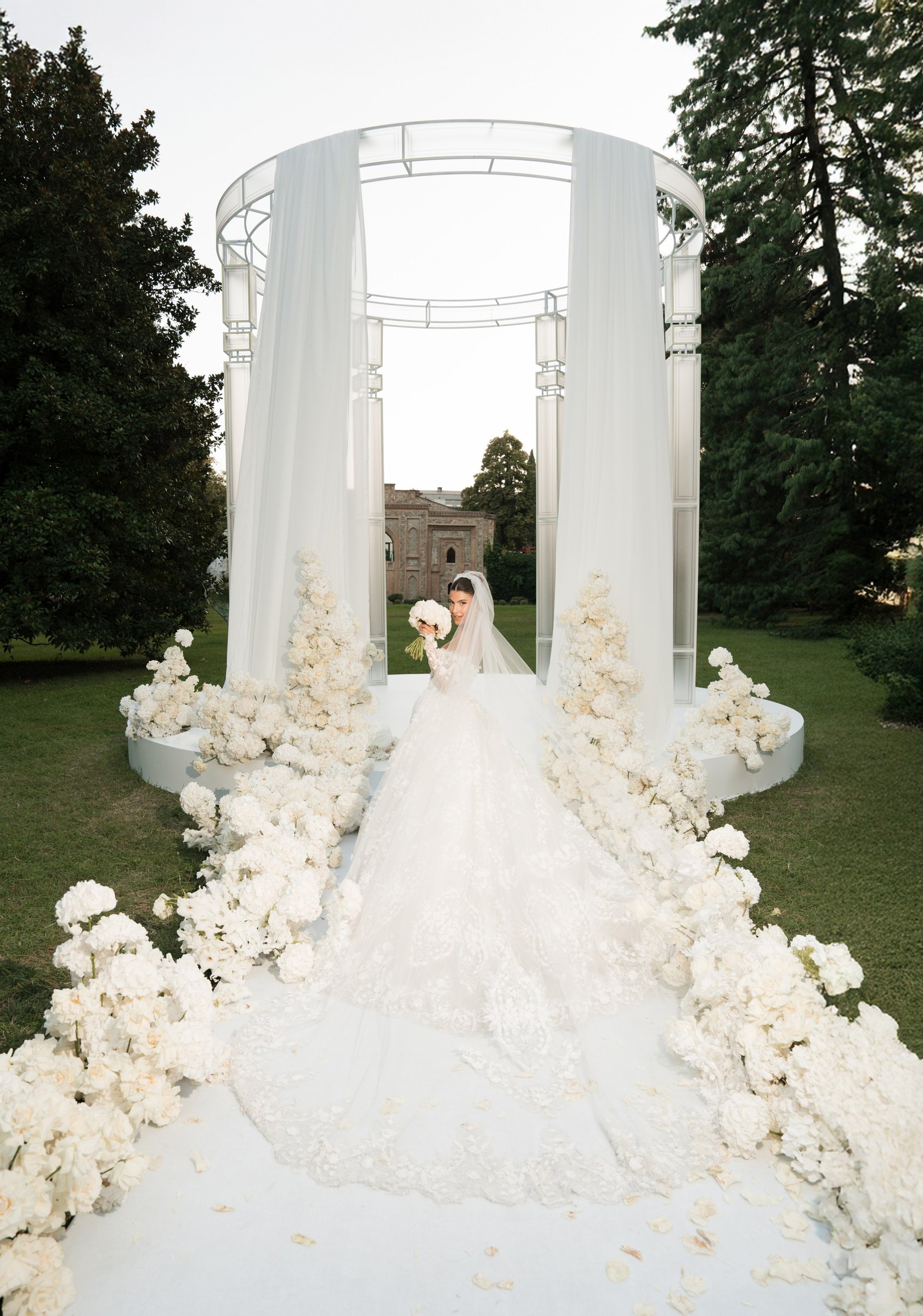 The couple inside the white rotunda, the train down the flower-lined aisle
