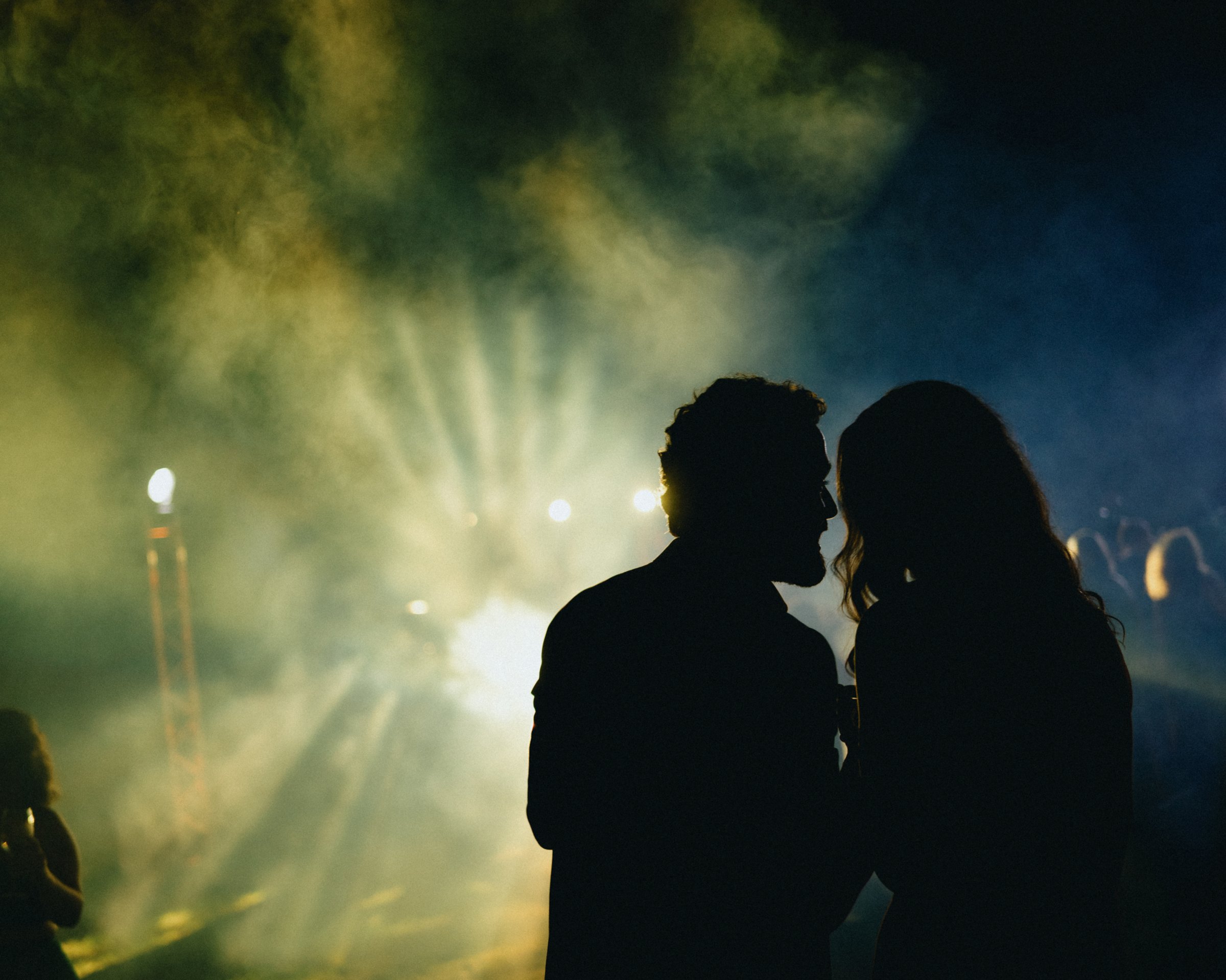 Silhouettes in stage smoke on the night dancefloor