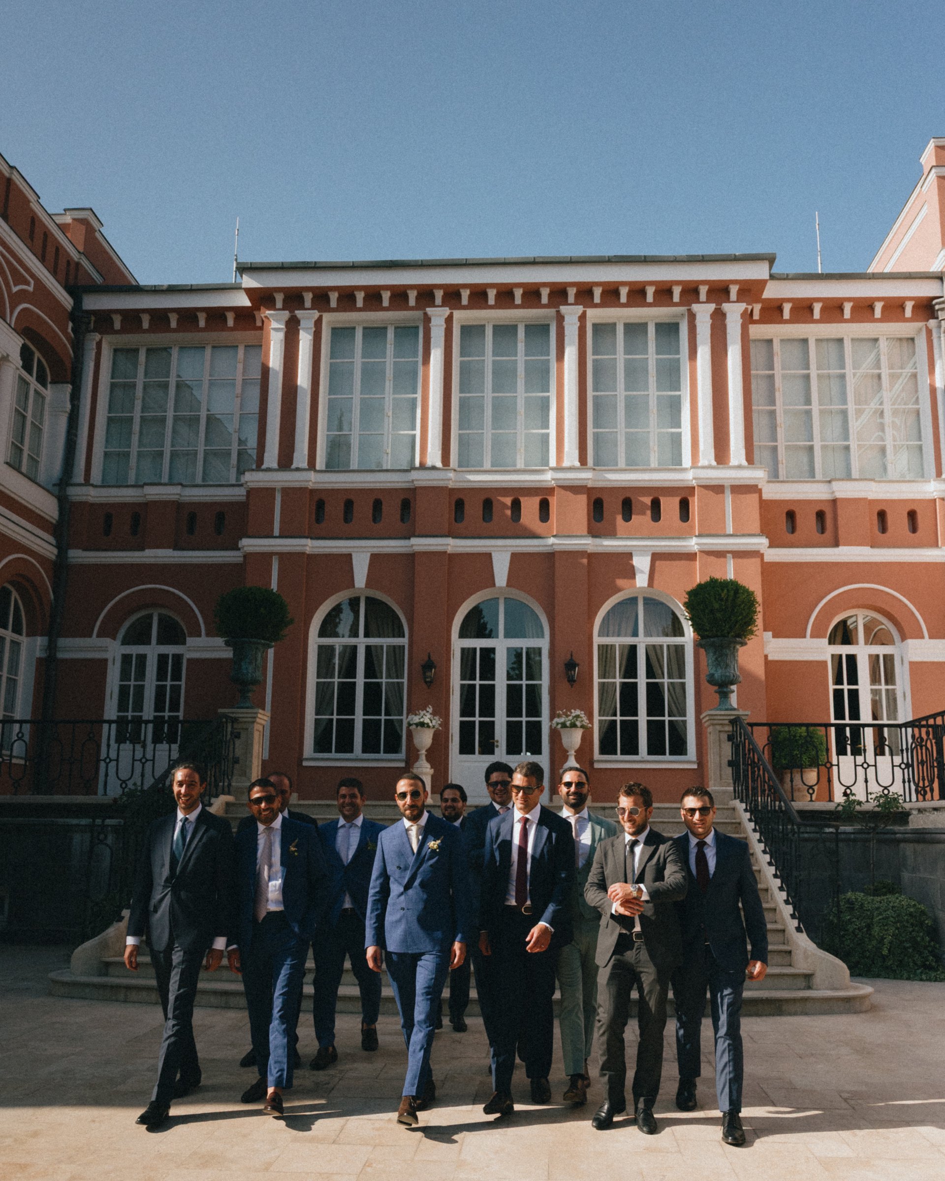 The groomsmen cross the palace courtyard