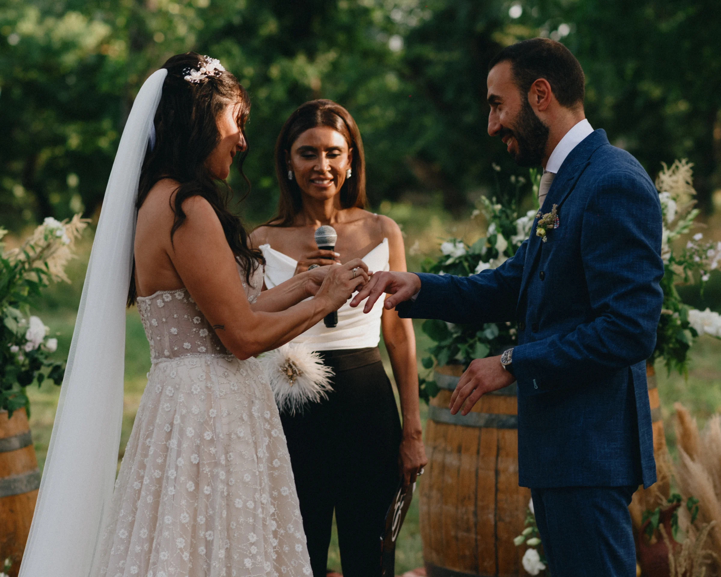 Ring exchange at the open-air ceremony among the wine barrels